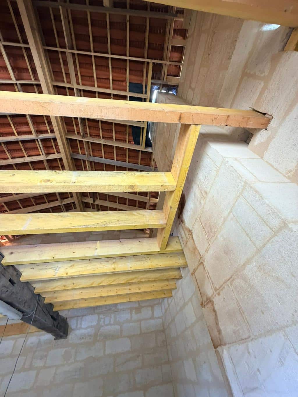 Charpente vue de l'intérieur d'un bâtiment en pierre